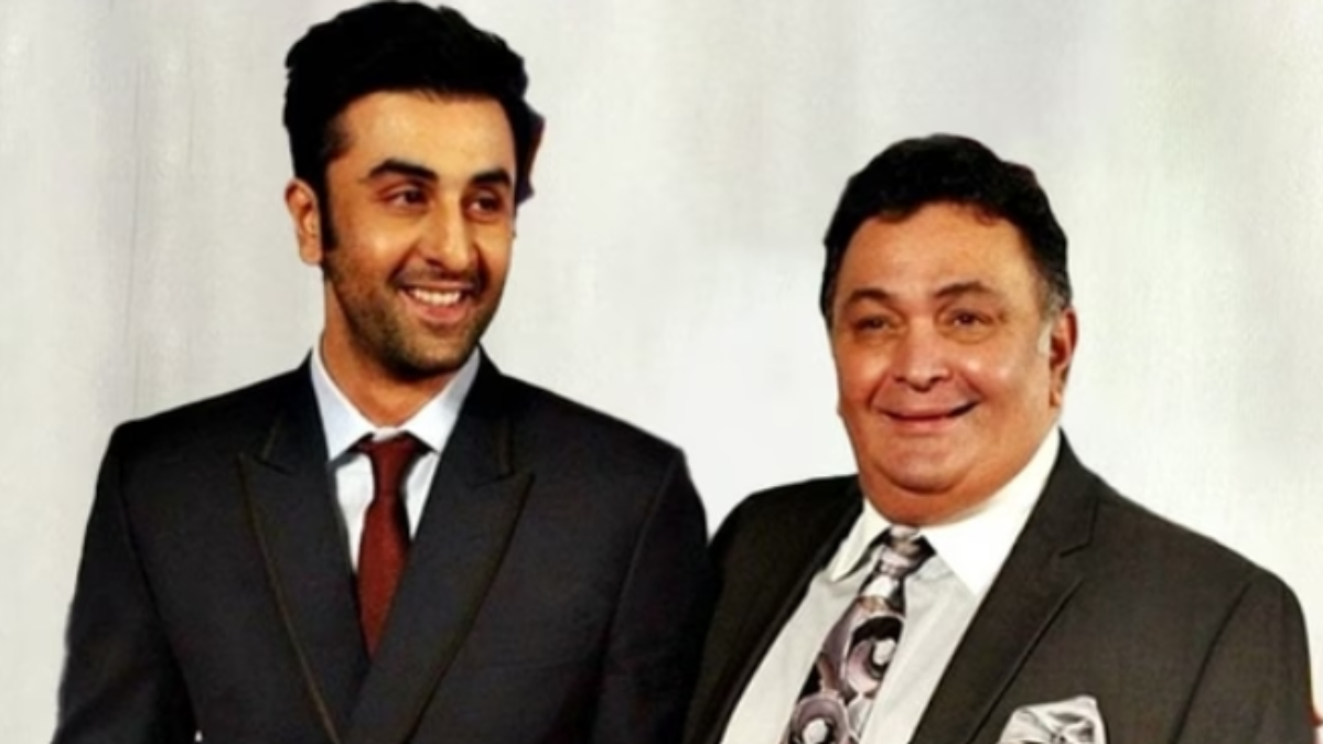 "Ranbir Kapoor sitting in a casual interview setting, expressing a thoughtful and reflective demeanor. The image captures Ranbir speaking about his late father, Rishi Kapoor, and his experiences growing up in a film family. His attire is relaxed, with a focus on his expressive facial features conveying sincerity and humility.